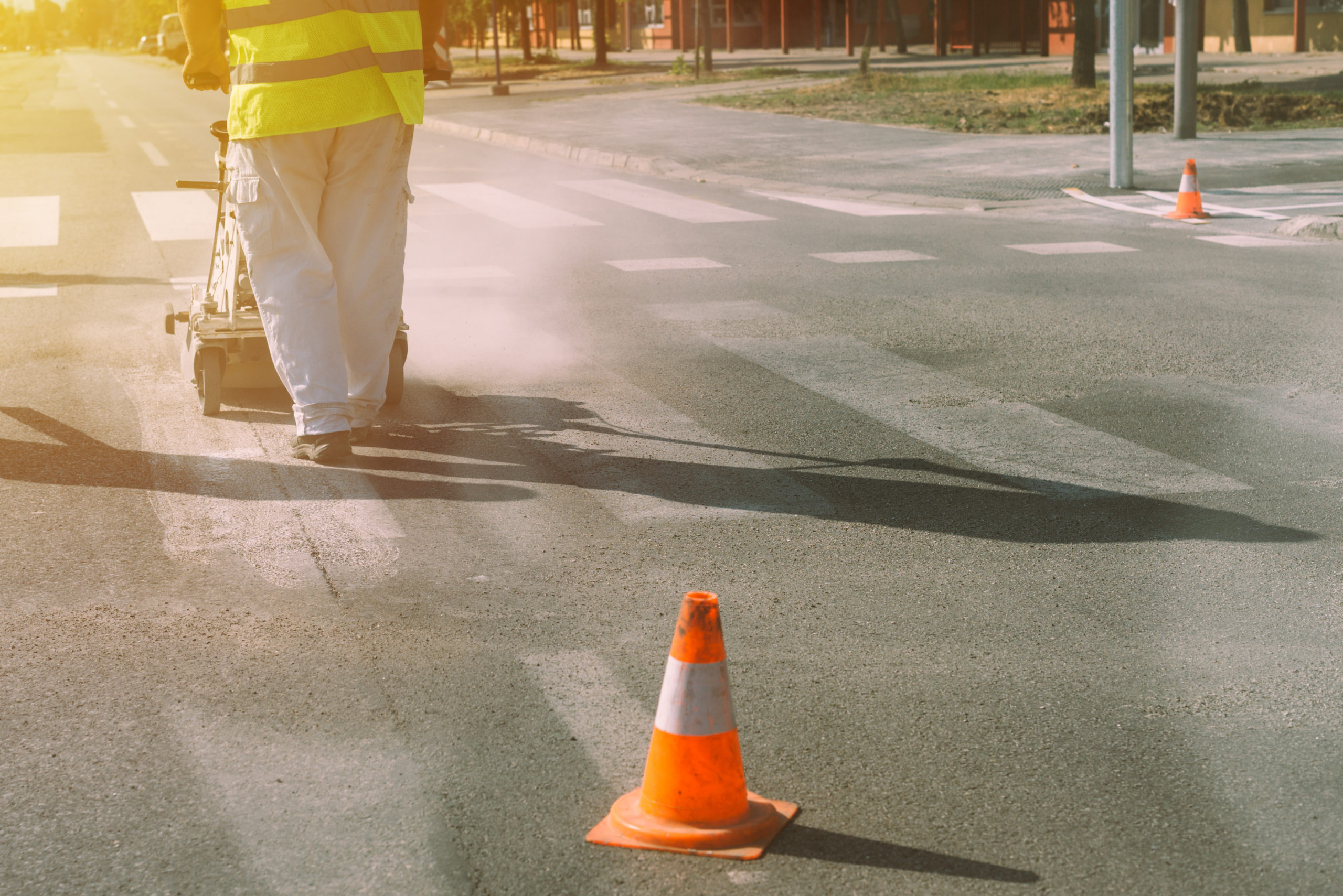Worker is painting zebra pedestrian crosswalk asphalt repair Rollplast